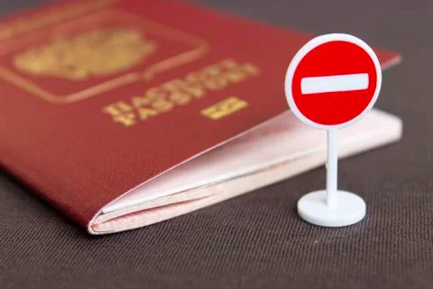 Stop illegal migration concept, Russian passport and stop sign close up. Stock Photos
