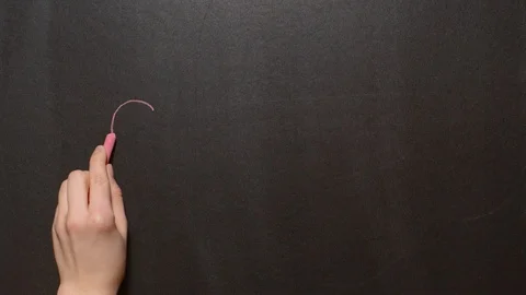 Stop. A left female hand writes the word "Stop" by red chalk on a black board Stock Footage 127298545