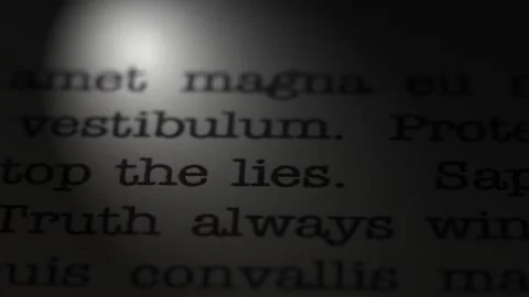 Stop the lies. Moving text printed on a page. Slow motion. Stock Footage 307286194