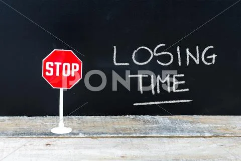STOP LOSING TIME message written on chalkboard Stock Photos