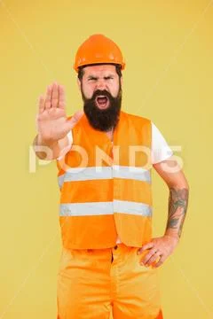Stop, mining area under construction. Mining engineer showing caution sign on Stock Photos