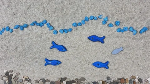 Stop Motion Animation of Blue Fish and Sailing Boat on Sand Stock Footage 330667968