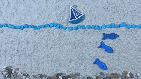 Stop Motion Animation of a Blue Sailing Boat and Swimming Fish on Sand Video stock 326144277