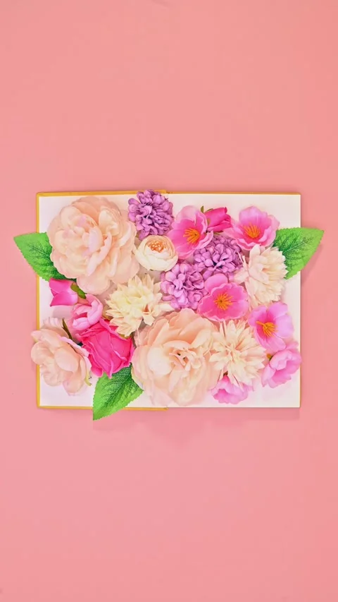 Stop motion animation of a book opening to reveal a burst of spring flowers. Stock Footage 313053678