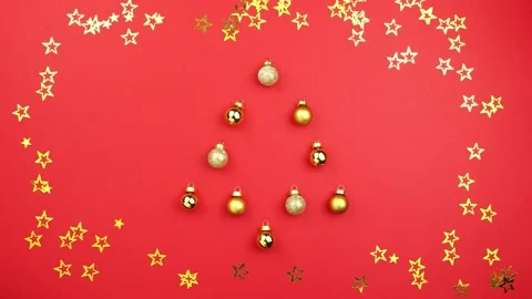 Stop motion animation christmas tree made of balls decoration on red background Video stock 139631796