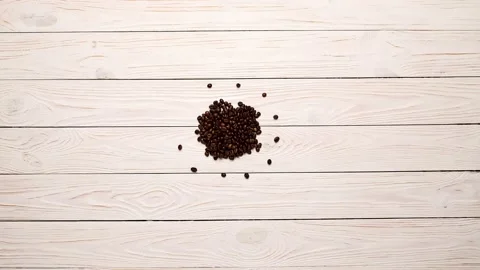Stop motion animation of coffee beans with sugar cubes and a coffee cup on a Video stock 195014539