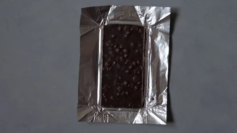 Stop motion animation concept. chocolate bar is unpacked, divided into slices Video stock 129024305