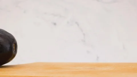 Stop motion animation of cutting fresh and organic eggplant Video stock 115047172