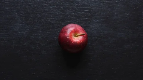 Stop motion animation of a dancing apple on slate background Stock Footage 125908658