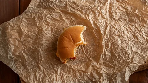 Stop motion animation, eating, burger is eaten piece by piece, top view Stock Footage 126031284