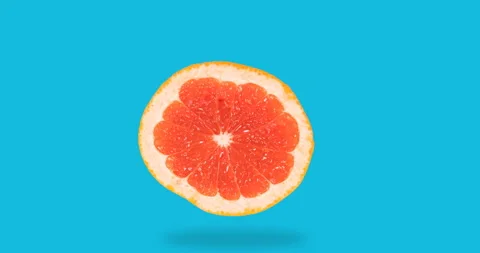 Stop motion animation of fresh grapefruit disappears, appears on a blue Stockbeeldmateriaal 139592053