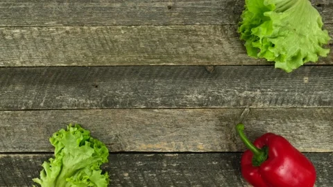 Stop motion animation- fresh vegetables on a wooden board. Video stock 152717248