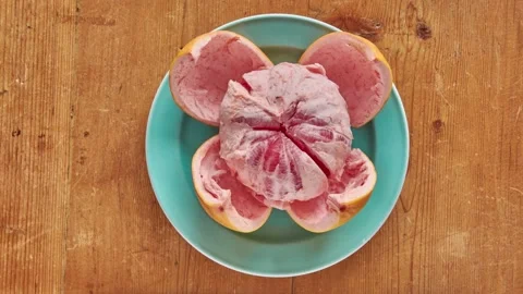 Stop motion animation of a grapefruit. Pealing a grapefruit in stop motion. F Stock Footage 141666808
