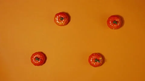 Stop motion animation of halloween mini pumpkins on orange background. Trick  Stock Footage 188877355