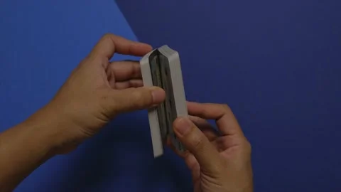 Stop motion animation of hands shuffling a deck of cards on two-tone table Stock Footage 200810920