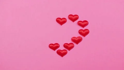 Stop Motion animation. Heart appears and disappears on pink paper background. Stock Footage 169744228