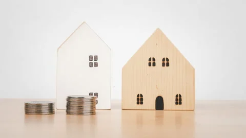 Stop motion animation house and money coin stack on wooden desk. Stock Footage 200091559