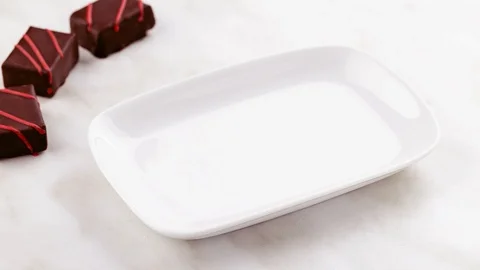 Stop motion animation of luxury handmade bonbons dancing on the plate Stock-Footage 111894043