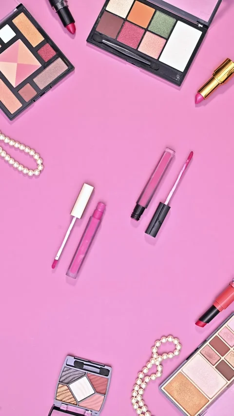 Stop motion animation of makeup products creatively dancing on pink background. Stock Footage 313053676