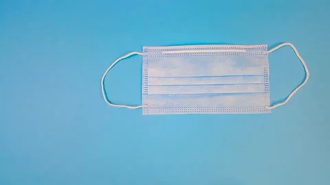 Stop motion animation. Mask, thermometer and many different pills on a blue Stock Footage 144817755