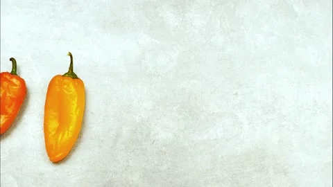 Stop motion animation with  multicolor pepper on a grey background Stock Footage 137058225