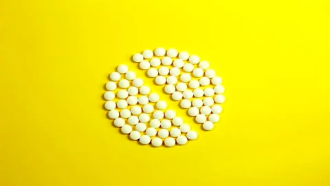 Stop motion animation of a pill on a yellow background 4K Stock Footage 155218237