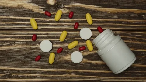 Stop motion animation. The pills spill out of the bottle. Medicines concept Stock Footage 143089986
