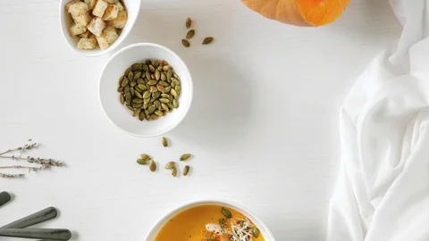 Stop motion animation Pumpkin soup, a piece of pumpkin, seeds and crackers. A pl Stock Footage 128426307