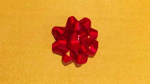 Stop Motion Animation - Red bow on a gold background. Chroma key Stock Footage 224169750