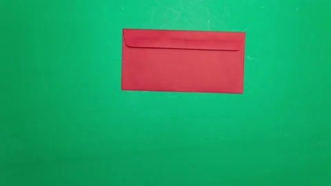 Stop motion animation red envelope on green background. 4k video Video stock 142317330
