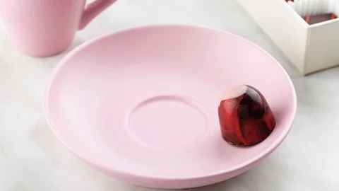 Stop motion animation of red luxury handmade bonbon dancing on pink plate Stock-Footage 111894045