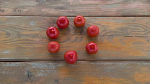 Stop motion animation ring of tomato moving in the middle of wooden table. Group Video stock 132461307