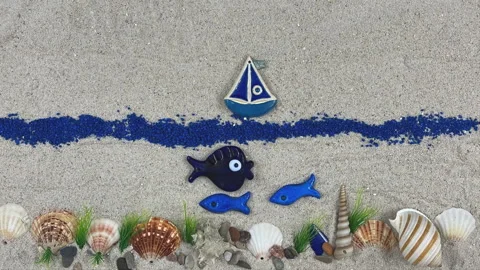 Stop Motion Animation of a Sailing Boat and Blue Fish on Sand Stock Footage 330667366