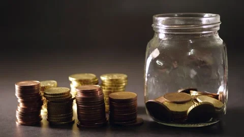 A stop motion animation of saving euro coins into a glass jar Stock Footage 160545430