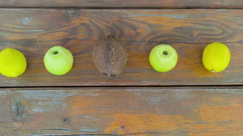 Stop motion animation scene of moving fruits on wooden table. Natural healthy fo Video stock 132292203