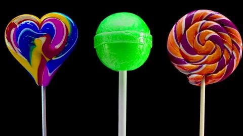 Stop motion animation set of lollipops on a black background. Sweet candy spiral Stock Footage 165629843