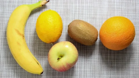 Stop motion animation. Several different fruits move on the surface. Stock Footage 154100067
