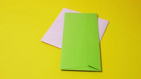 Stop motion animation stack of colored envelopes on a yellow background Stock Footage 188877284