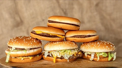 Stop motion animation, stack, pile of burgers appearing, heap of fast food Vídeo Stock 126031274