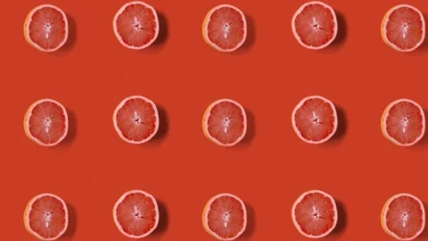 Stop motion animation Top view on grapefruit halves over orange table. Stock Footage 135415660