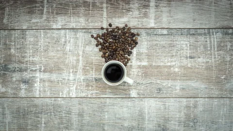 Stop motion animation of transformation roasted coffee beans to cup of coffee Stock Footage 105060599