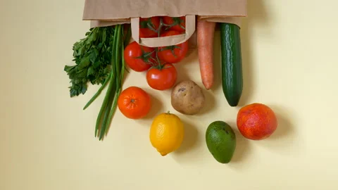 Stop motion animation vegetables and fruits on cream color background Stock Footage 152649879