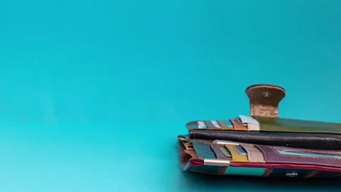 Stop motion animation video of paper money going out of a colorful wallet Stock Footage 131732022