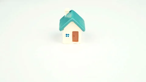 Stop motion animation by white toy house for sale. Real estate concept Stock Footage 127302599