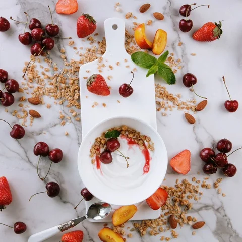 Stop motion animation, yogurt spin on white ceramic board, on a marble backgroun Stock Footage 128426332