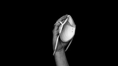 Stop motion animation.Hand holding a white medical mask Stock Footage 127987031