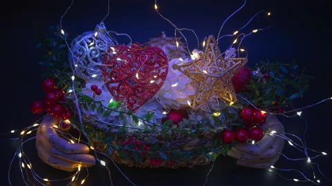 Stop motion animationTwo wooden hands hold a basket full of Christmas ornaments Video stock 143363396