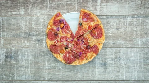 Stop motion of appearance of fresh pizza on a wooden table Stock Footage 104858829