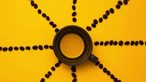 Stop motion of black coffee in a cup with coffee beans making coffee text. Video stock 220559612