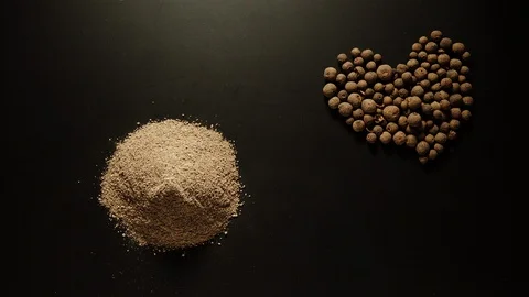 STOP MOTION: Black pepper powder is piled up on the black table Stock Footage 108199252